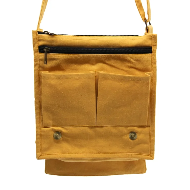 Cotton canvas yellow messenger bag displayed on a wooden table