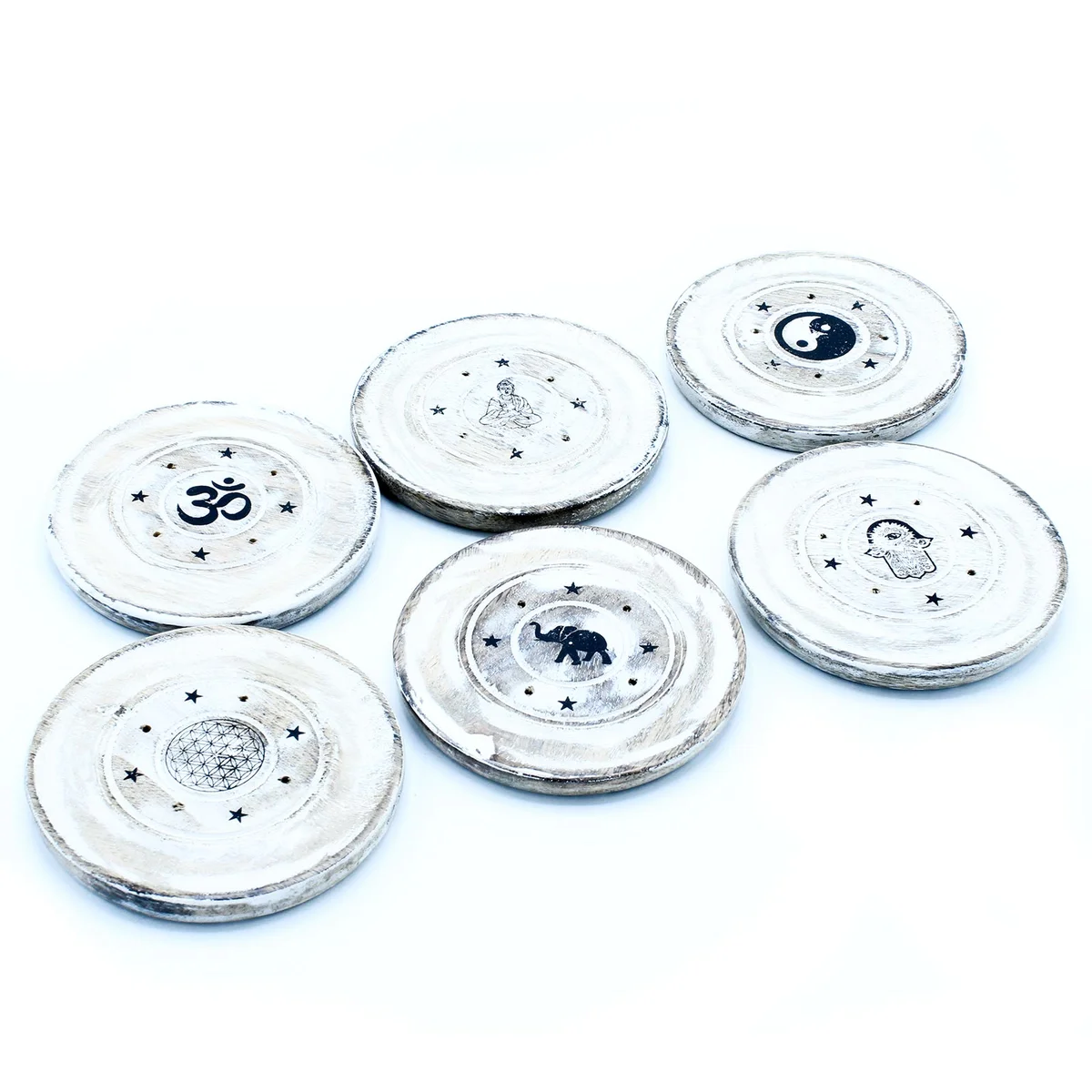 White washed incense disc holder with cone incense on a minimalist wooden surface against white background