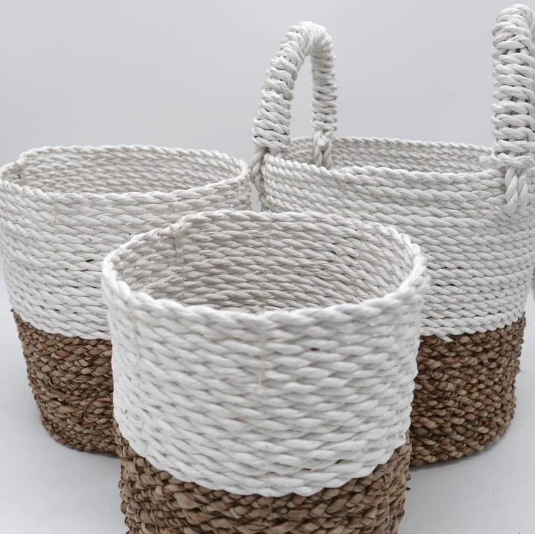 Seagrass basket set in natural white, three woven baskets displayed together on a wooden surface.