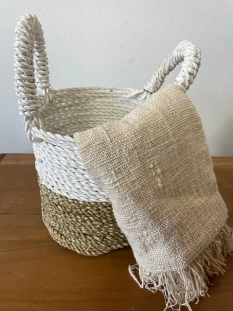 Three natural white seagrass baskets arranged in a set, showing their woven design.