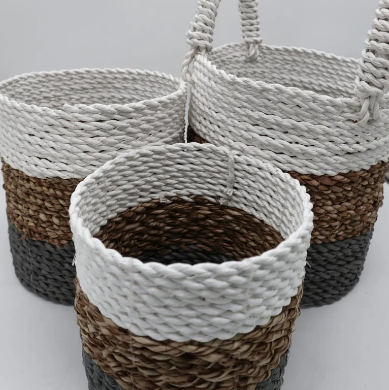 Grey, natural and white seagrass storage basket set, woven baskets stacked side by side.