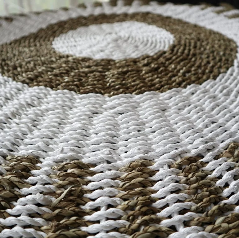 Round seagrass white and tan basket, sun‑touched, 1m diameter.
