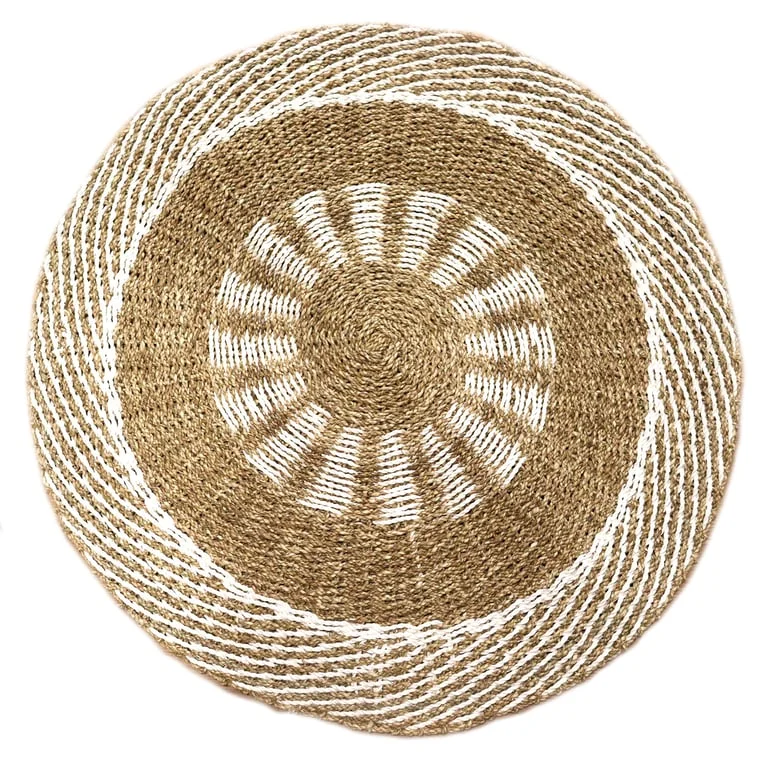 Round seagrass basket in white and tan detailing, 1m in diameter, displayed against interior sun décor.