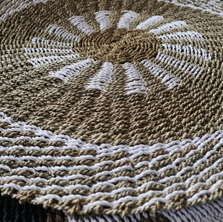 Round seagrass storage basket in white and tan, woven seagrass texture.