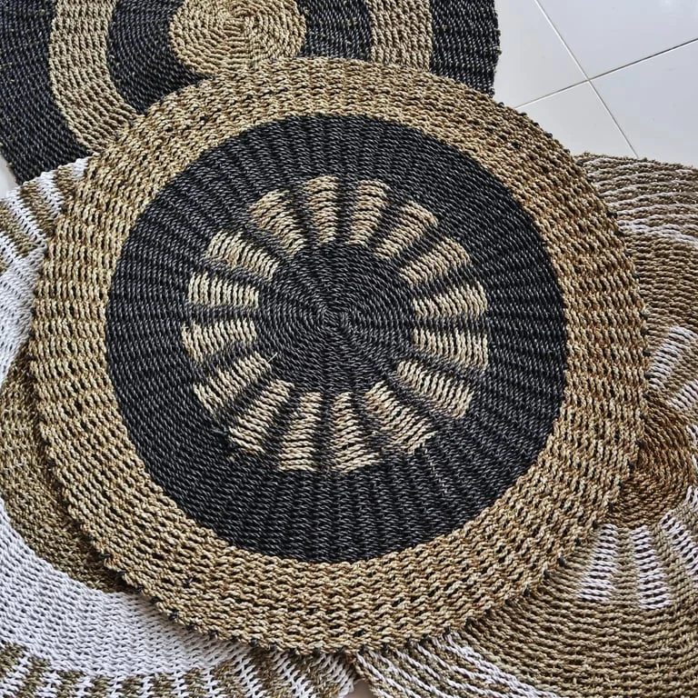 1m round black and tan seagrass basket on neutral background