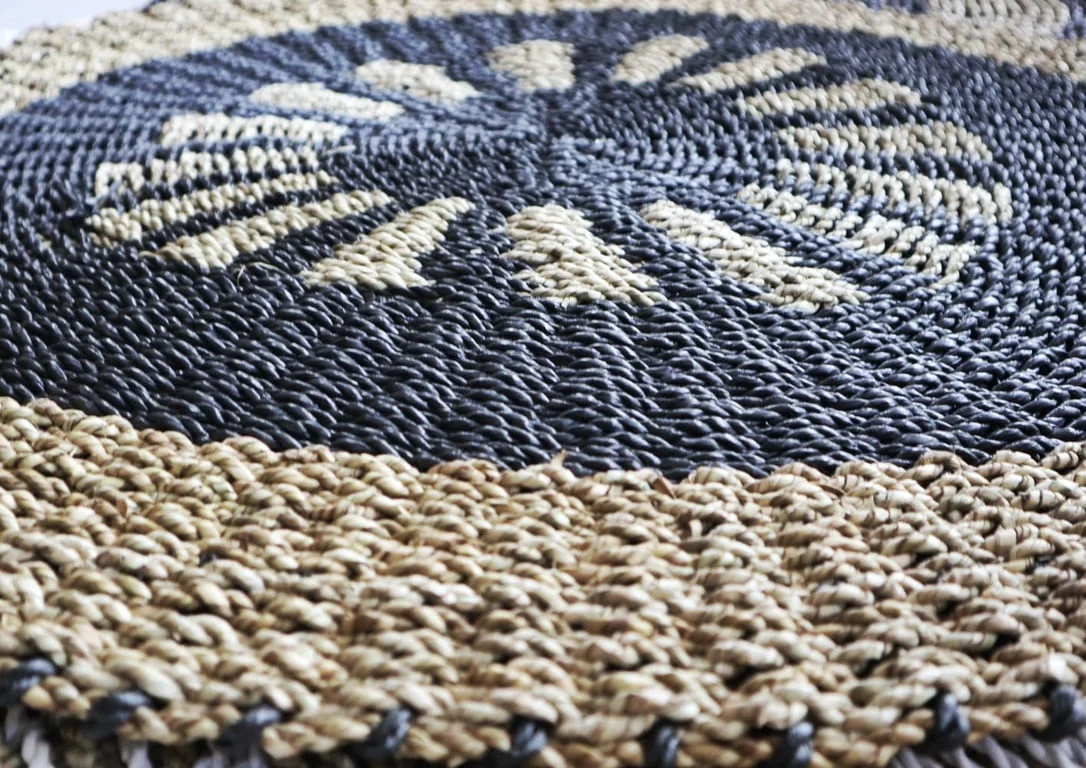 1m seagrass basket, round shape with black and tan weave and inner sun design