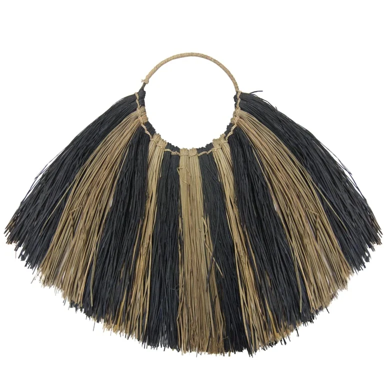 Large seagrass wall decor fan in zebra pattern draped over wall