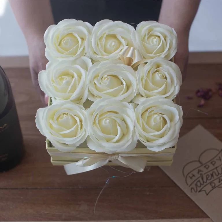 Soap flower bouquet of thirteen cream roses formed into a heart shape.