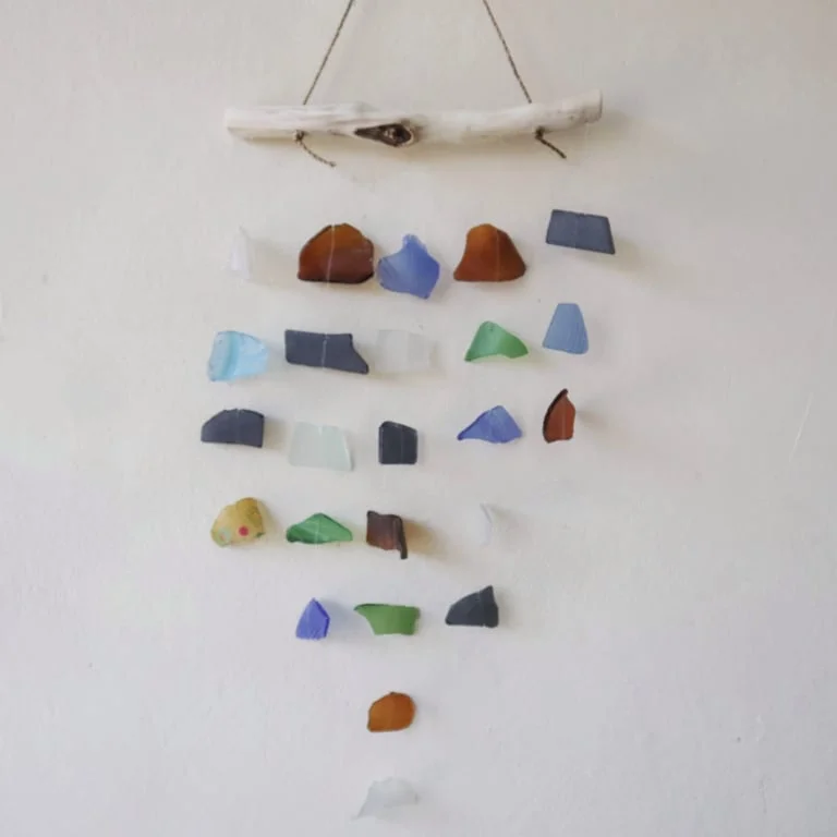 Minimalist wall decor featuring five vertical strings in assorted colours, multi string wall decor