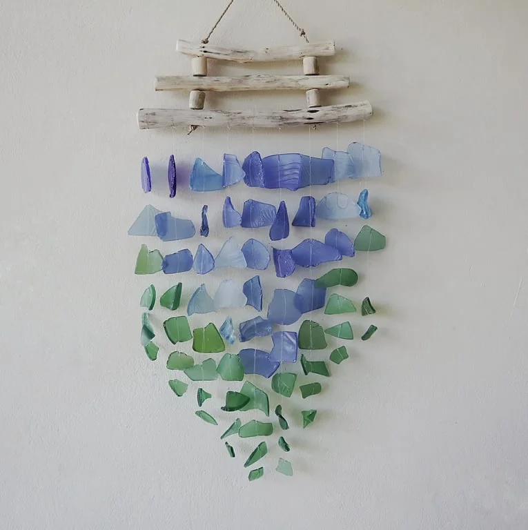 Modern wall art featuring three sticks in blue and green.