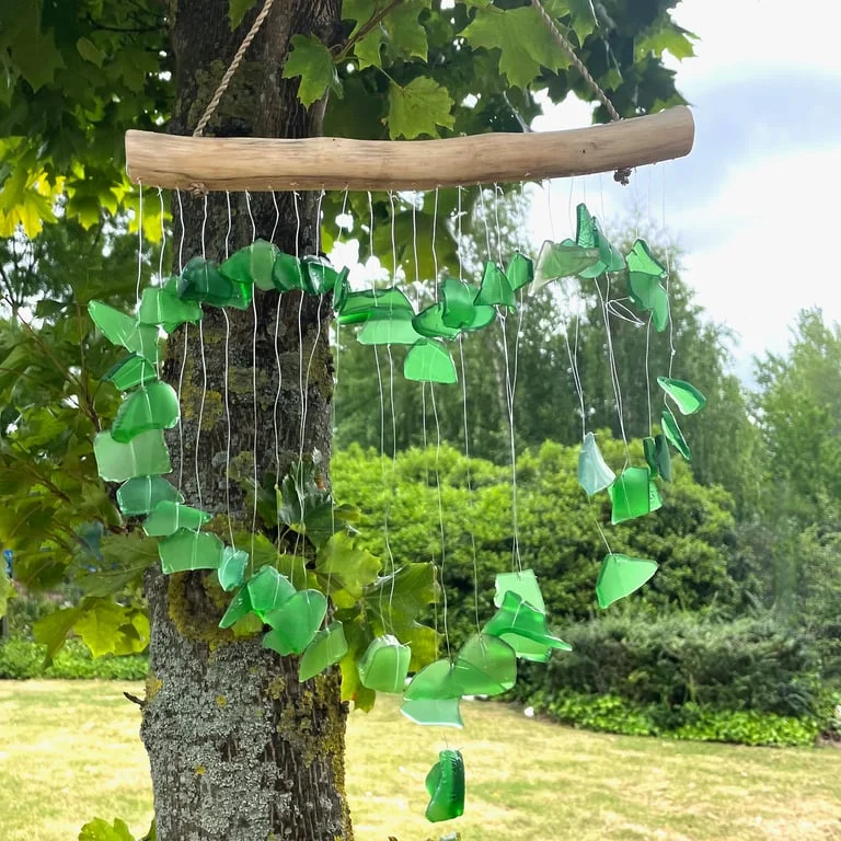 Green Love Chime hanging on a string, a charming outdoor decorative chime that adds a touch of nature to gardens