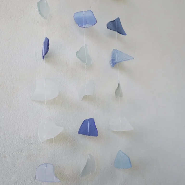 Abstract wall art featuring three blue and white drop shapes.