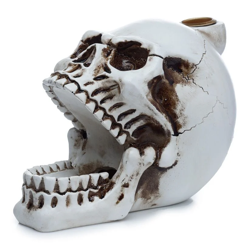 Skull-shaped open mouth incense holder with backflow design, showing smoke flowing from mouth downwards on dark background