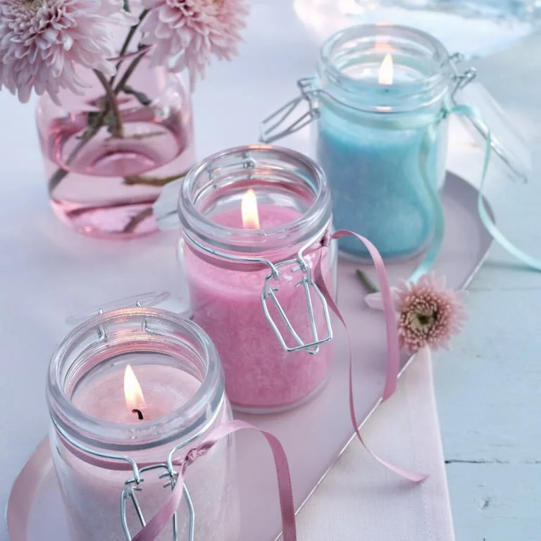 Olive wax jar candle in antique rose colour, slender glass jar with soft pink wax visible