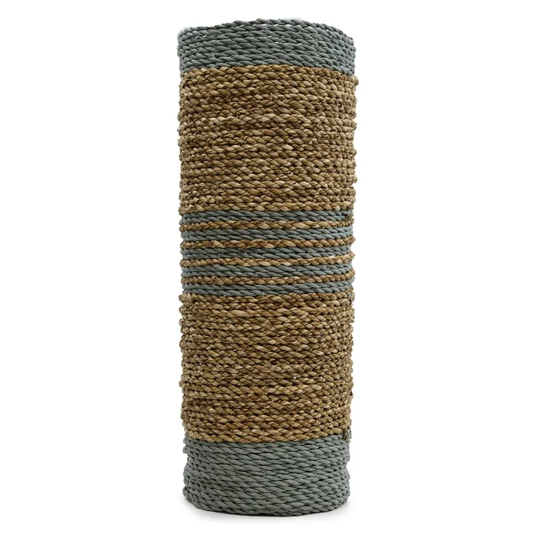 Two seagrass vase set with raffia accents beside two matching seagrass bins, arranged on a light floor.