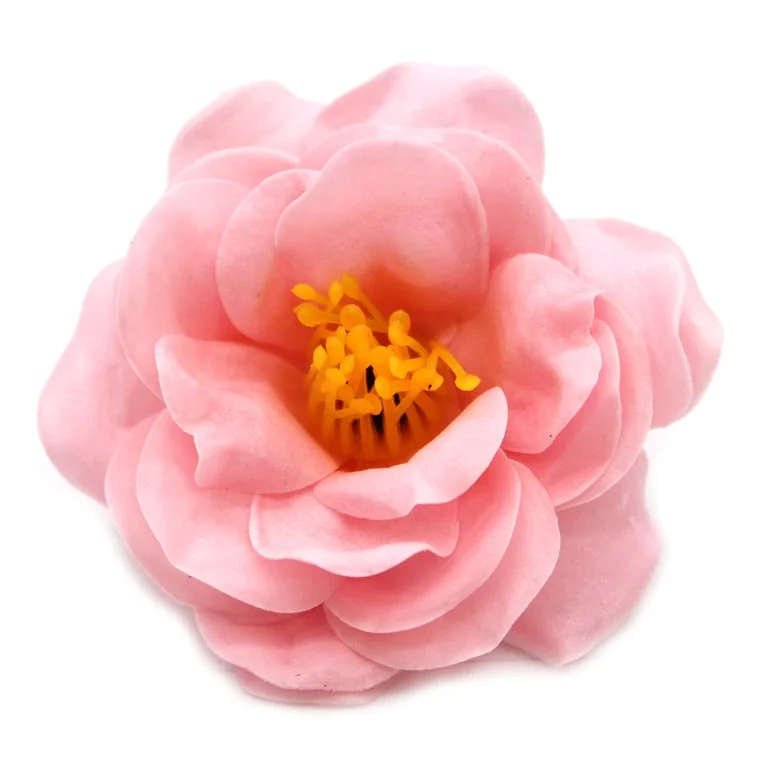 Light pink craft soap flower shaped like a camellia flower.