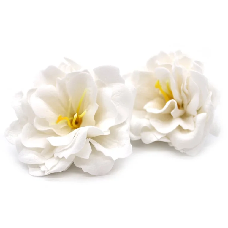 White craft soap flower shaped like a small peony.