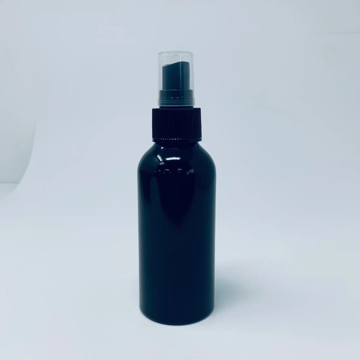 120ml black aluminium bottle with black spray cap shown as a black spray bottle on white background