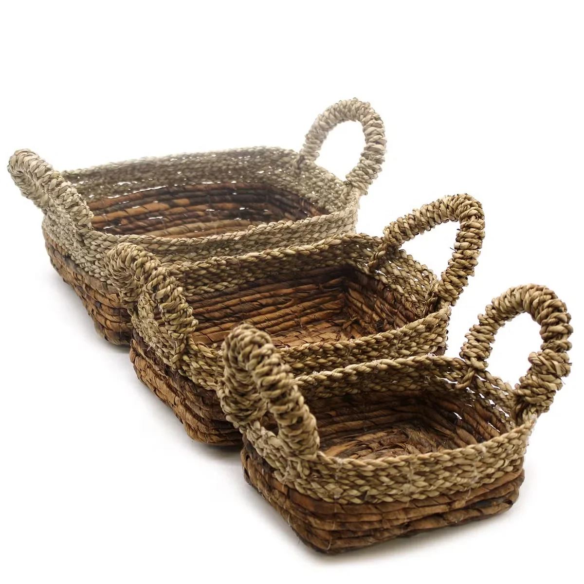 Set of three square banana leaf and seagrass baskets displayed together.