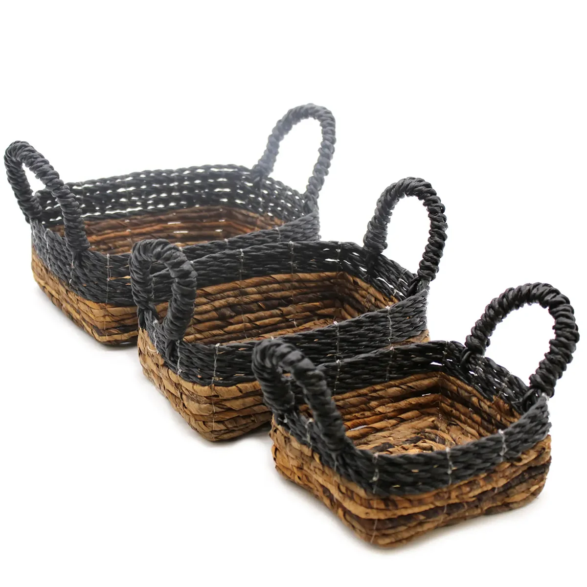 Hand‑woven hitam raffia baskets on banana leaf backdrop, set of three.