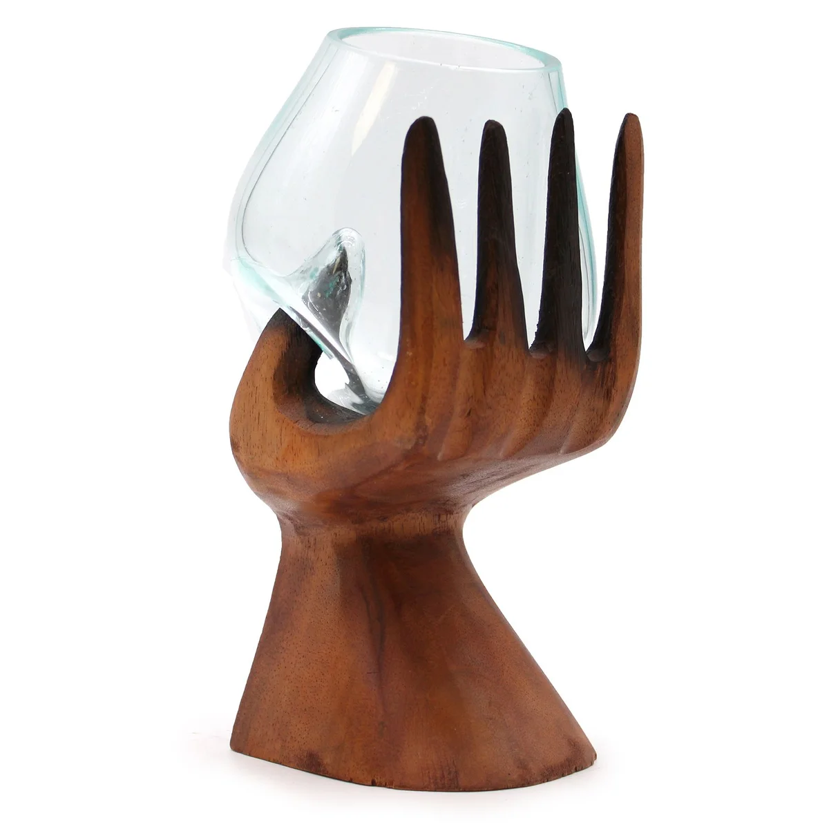 Carved hand holding a molten glass bowl ornament with smooth, flowing glass details