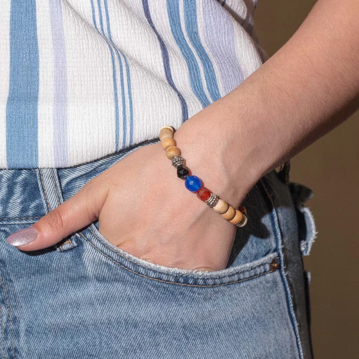 Tri Hita Karana Bangle in silver finish, a stylish appreciation jewellery piece with engraved design details on wrist model