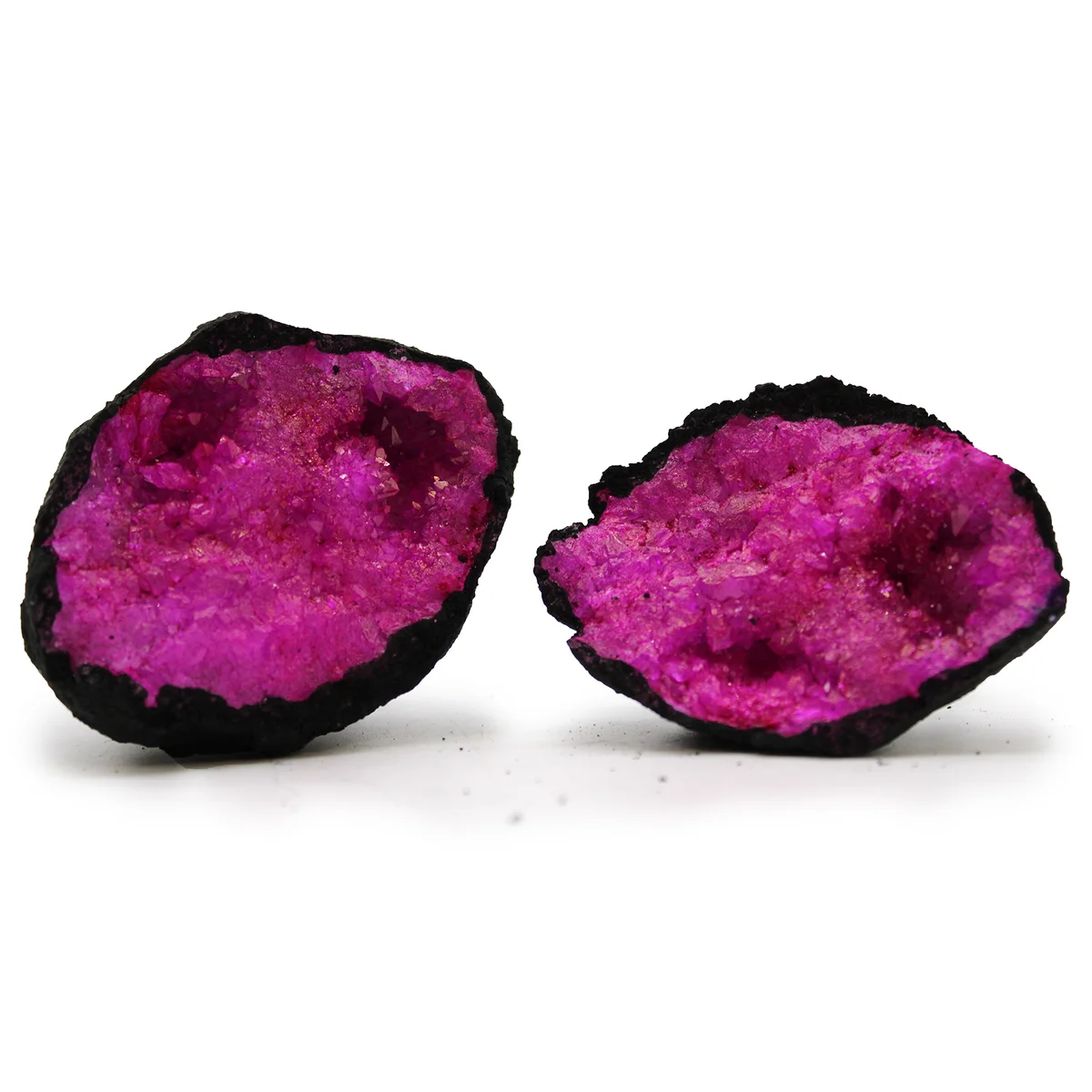 Dark red and pink coloured calsite geode on black rock, pink calsite ornament with natural crystal formations