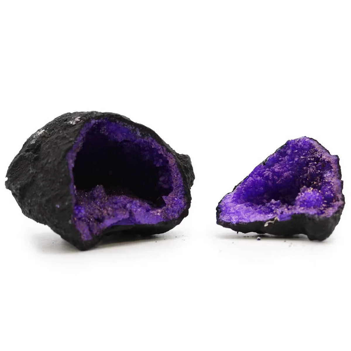 Purple coloured calsite geode with black rock base, decorative geode piece with natural crystal formations