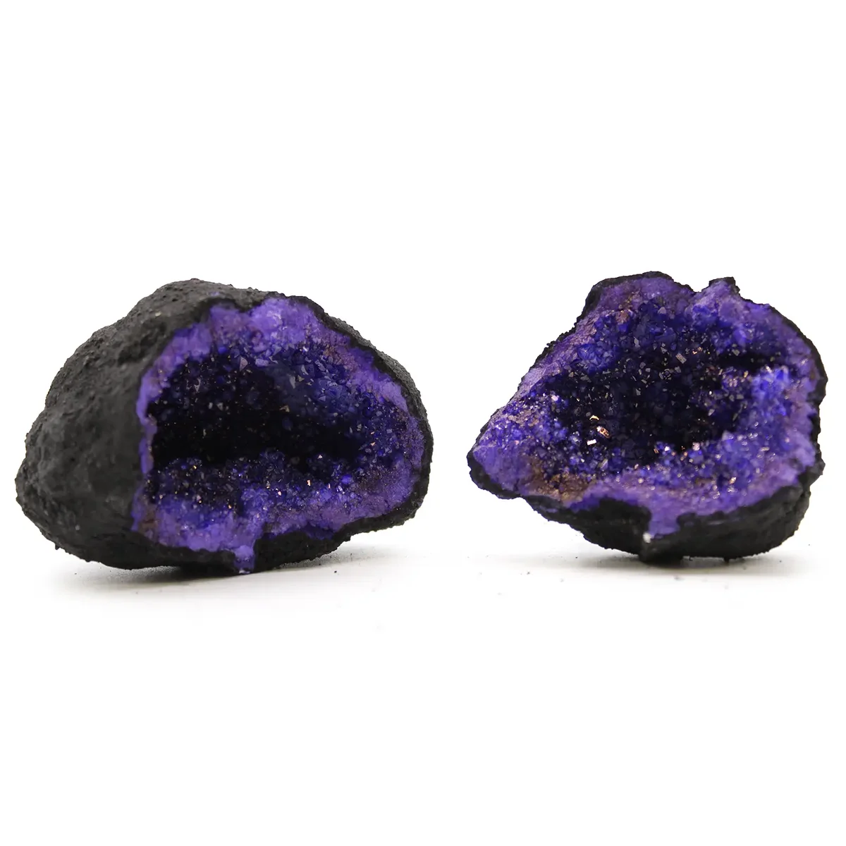 Turquoise purple geodes in black rock with vibrant crystal formations on a white background