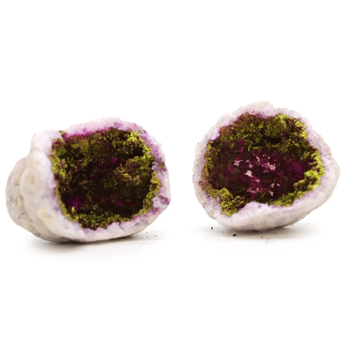 Pink and gold coloured calsite geodes displayed as natural rock decor pieces on a white background