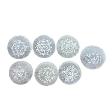 Set of 7 chakra charging plates arranged in a row, each plate featuring different chakra symbols and colors