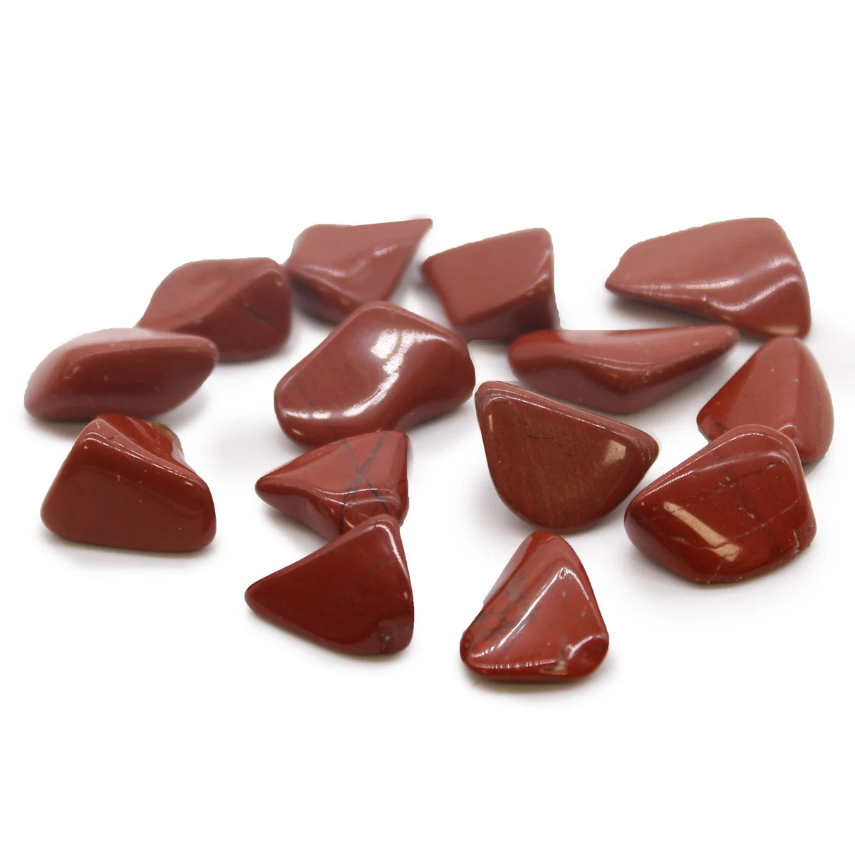 Smooth red jasper tumble stone with natural patterns and polished finish on a white background