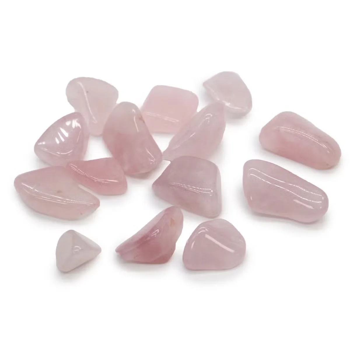 Polished rose quartz M tumble stone healing crystal ornament with smooth surface and soft pink color on white background