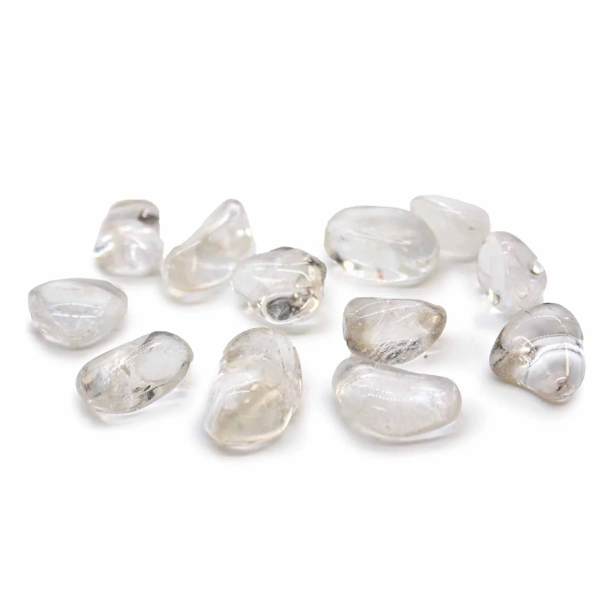 Collection of polished rock crystal tumble stones Grade A in various shapes and sizes on a white background