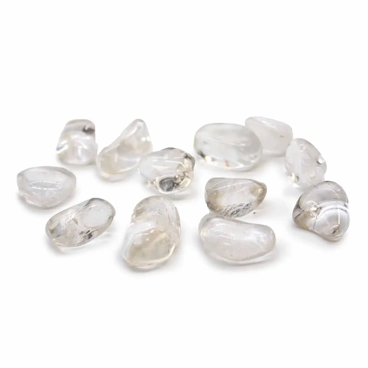 Collection of polished Rock Crystal Grade A tumble stones in medium size on white background
