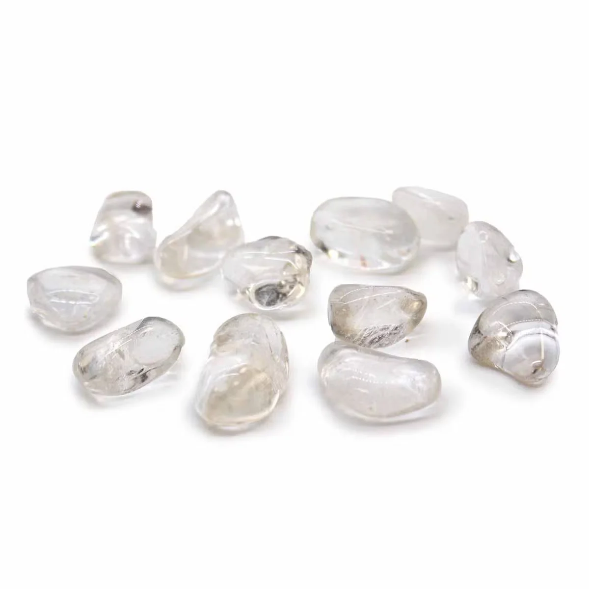 Medium-sized Grade A rock crystal tumble stones shown as decorative crystal stones on a white background