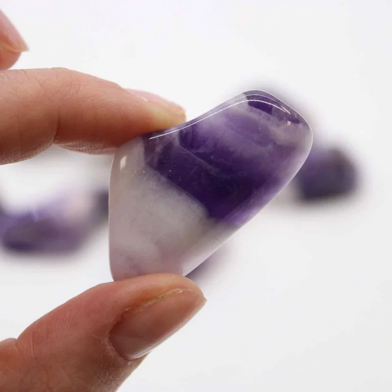 Grade B amethyst banded stones displayed in a small assortment, showcasing pale purple to rich violet tones.