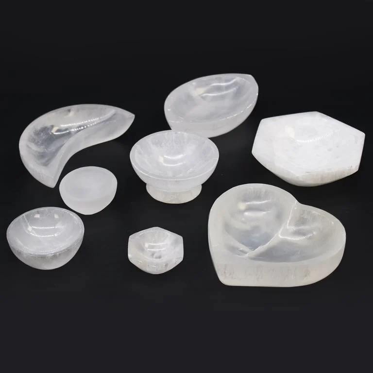 Round 15cm natural stone bowl made of smooth, translucent selenite with subtle striations on a white background