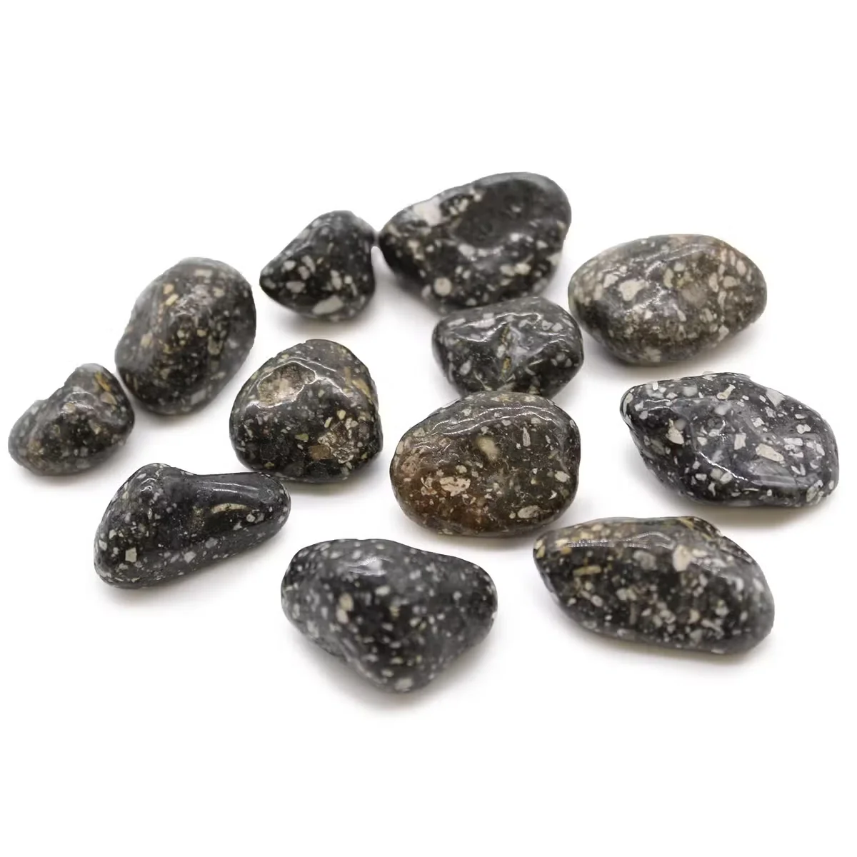 Medium African stone ornaments shaped like guinea fowl tumble stones arranged on a white background