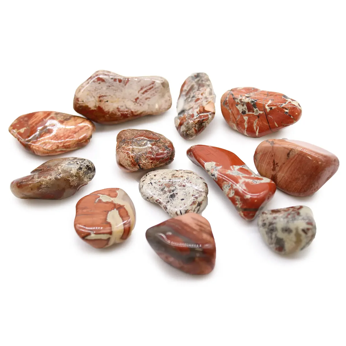 Medium polished light jasper stones with brecciated patterns, smooth and rounded tumble stones from Africa