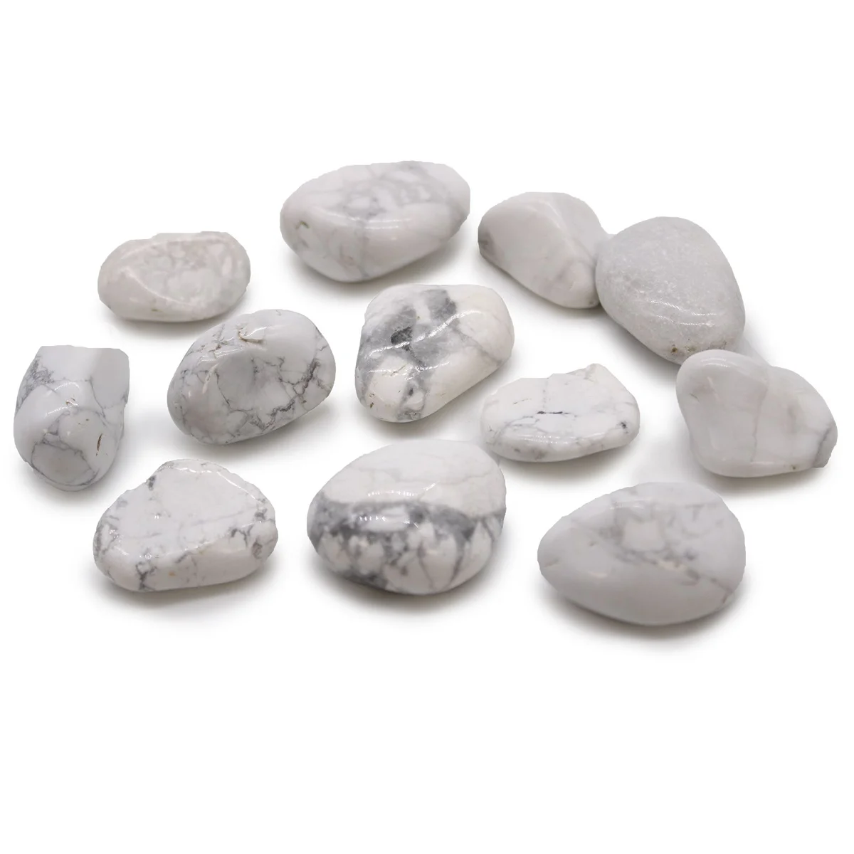 Medium polished white howlite stones with smooth surfaces and natural marbling, grouped together on a white background