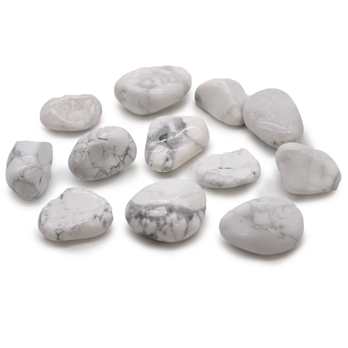 Medium white African magnesite stones with smooth, polished surfaces in a small pile on a white background