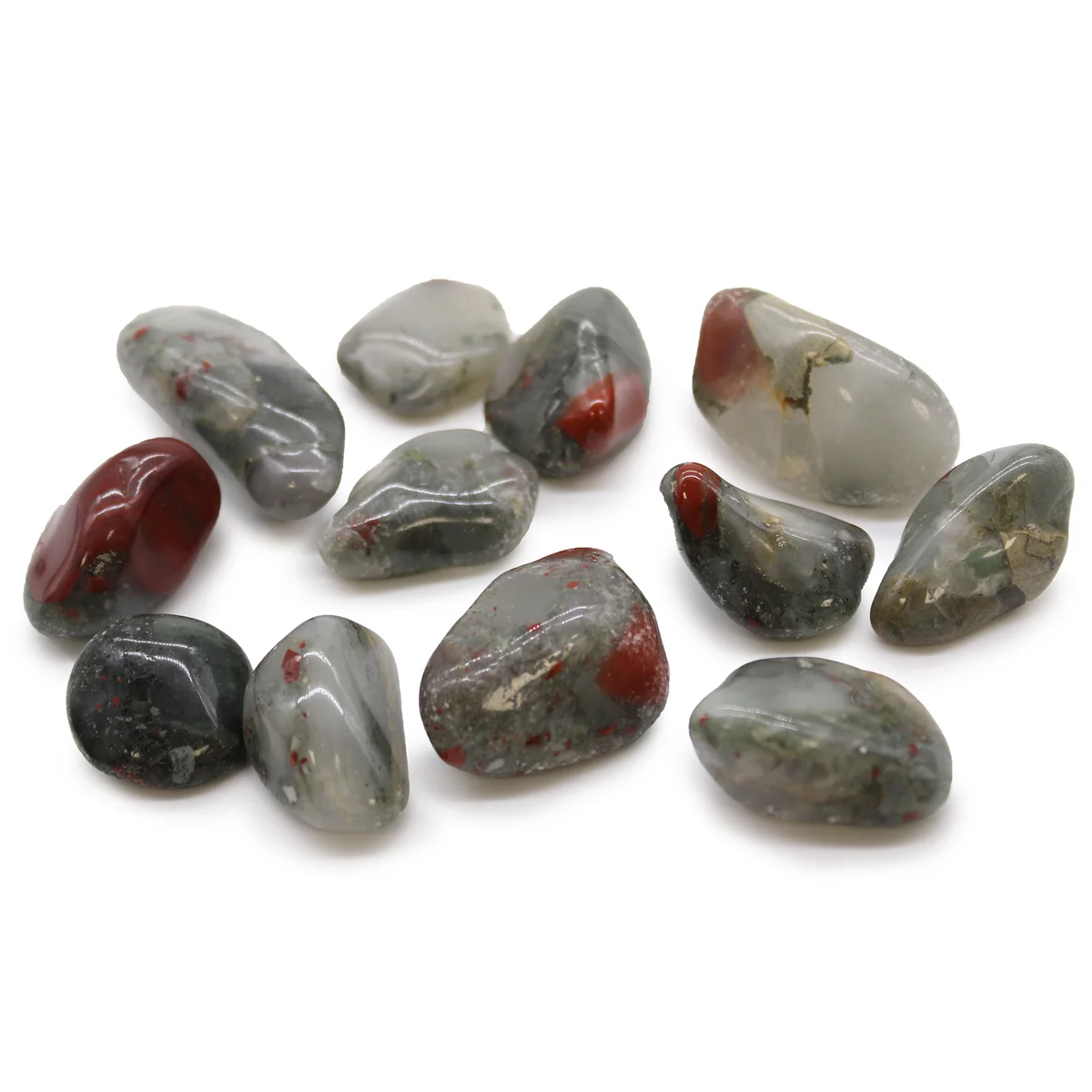 Medium tumble stones in deep green with red specks, polished bloodstone from Africa arranged on white background