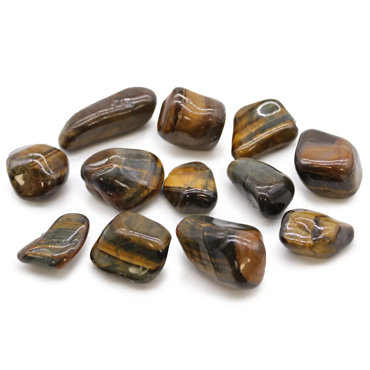 Varigated medium African tumble stones in polished tigers eye with brown and gold hues on white background
