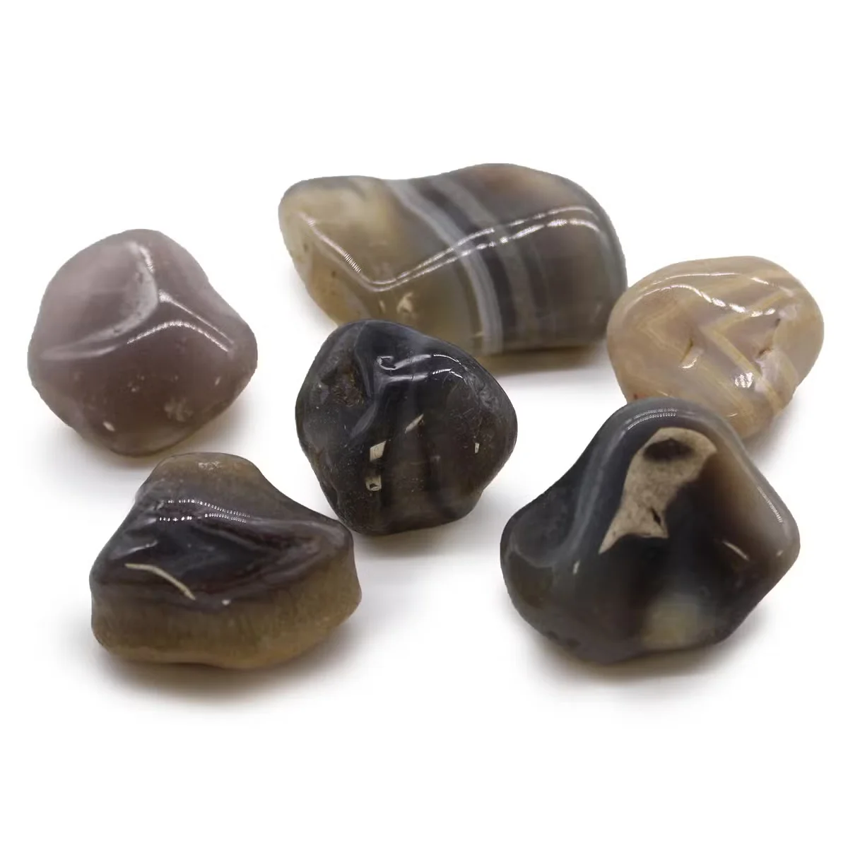 Large grey Botswana agate stones polished as large African tumble stones, showing smooth surfaces and natural patterns