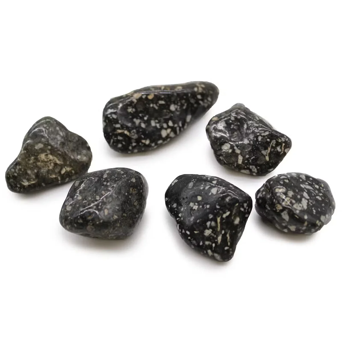 Large decorative stones featuring Guinea Fowl pattern, set as African tumble stones in a natural arrangement