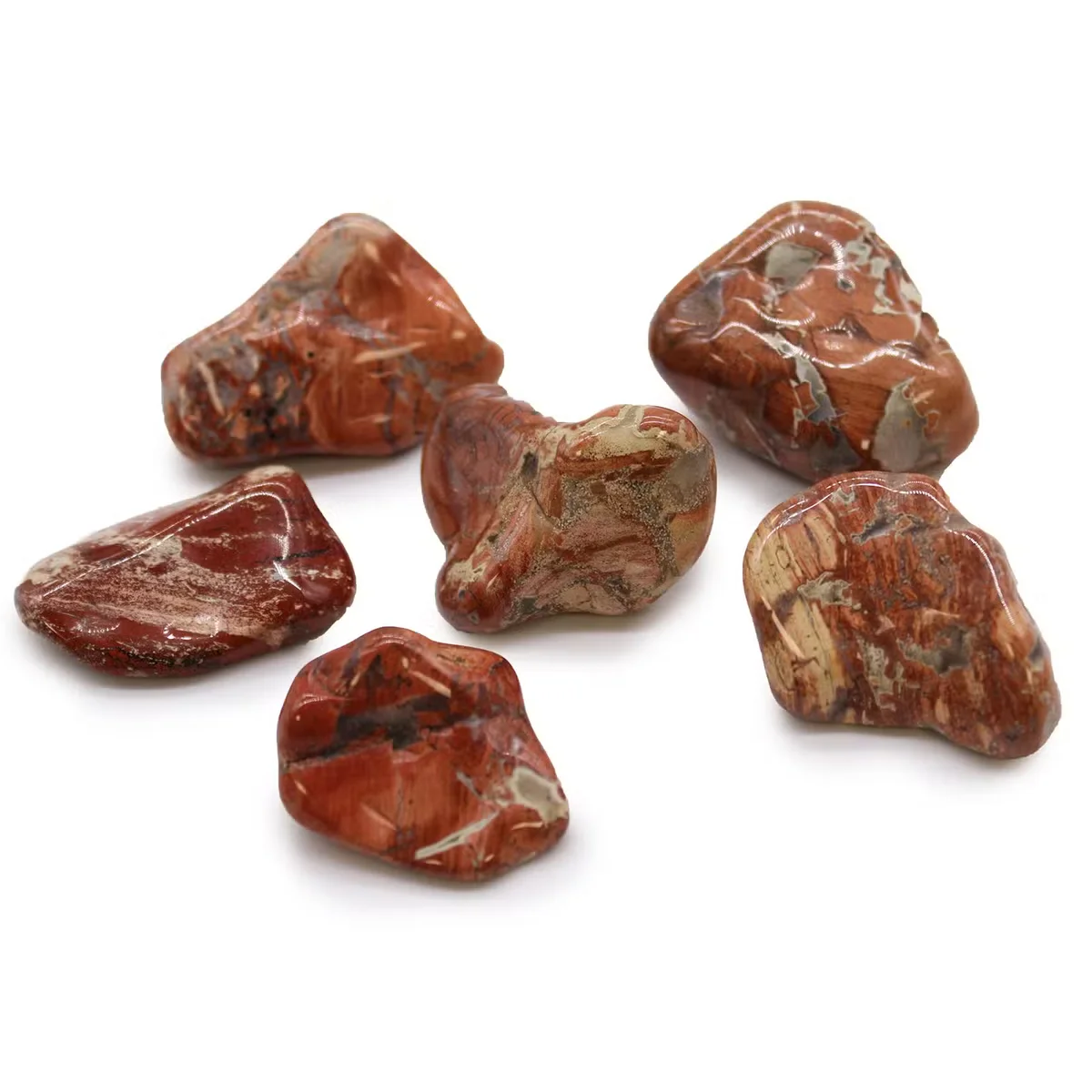 Large natural tumble stones made of light brecciated jasper from Africa, polished with smooth surfaces and earthy tones
