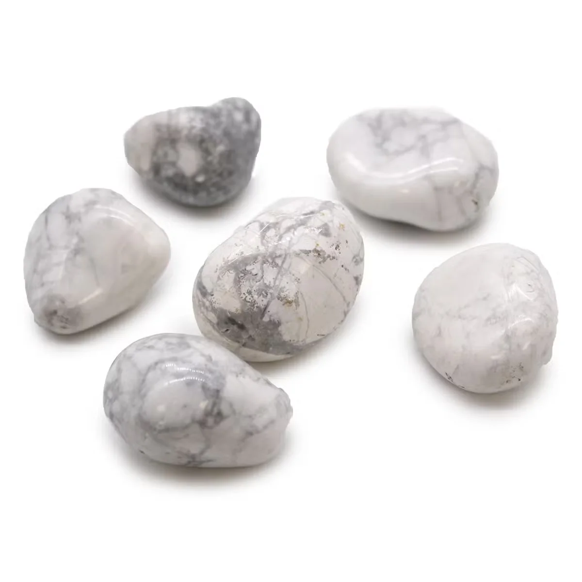 Large white howlite magnesite decorative tumble stones with smooth polished surfaces and natural veining patterns