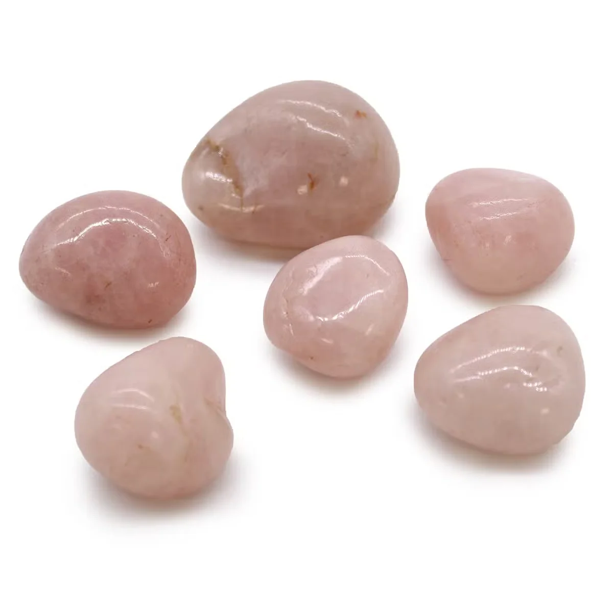 Large tumble stones made of rose quartz, showcasing smooth, rounded surfaces.