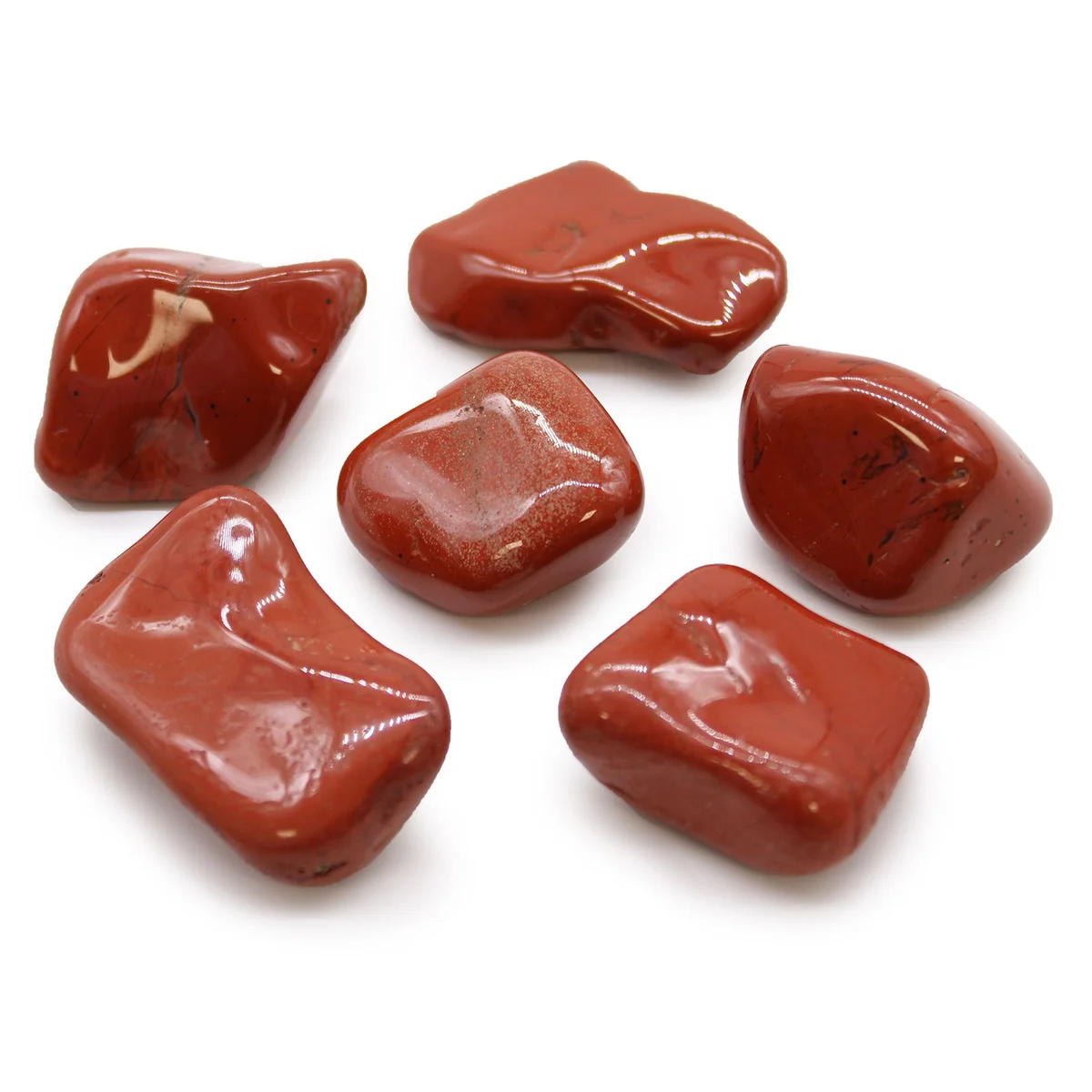 Collection of large red jasper tumble stones from Africa displayed on a white background